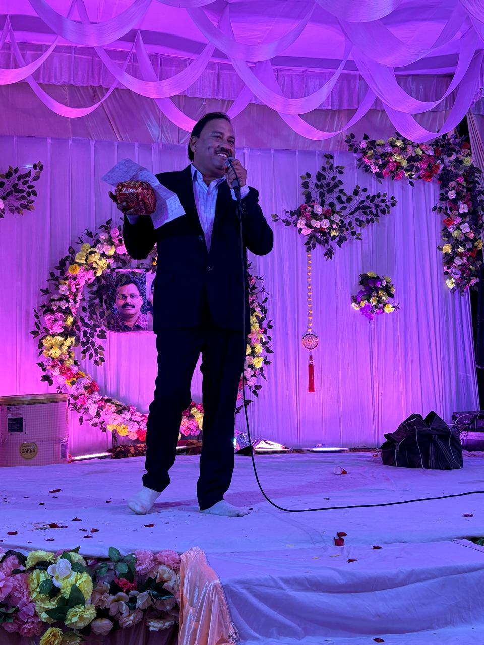 Jash Events coordinator hosting on a floral stage lit in purple